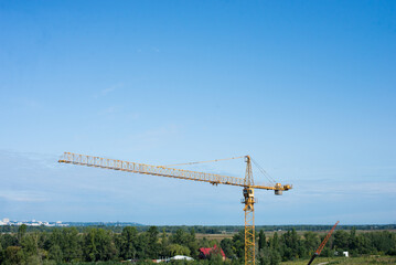 Industrial landscape with silhouettes of cranes on the sunset background