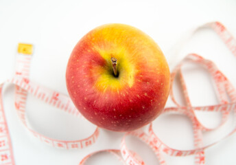 red apple and measure stripe on white background,diet concept