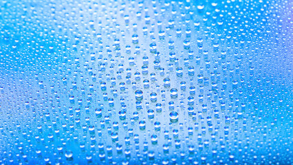 Drops of water. Abstract gradient backdrop. Drop texture. Blue gradient. Heavily textured image. Shallow depth of field. Selective focus
