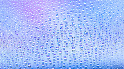 Water drops. Texture of the drops. Abstract gradient background. Cold rainbow gradient. Heavily textured image. Shallow depth of field. Selective focus
