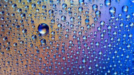 Water drops. Texture of the drops. Abstract gradient background. Multicolored blue-gold iridescent gradient. Heavily textured image. Shallow depth of field. Selective focus