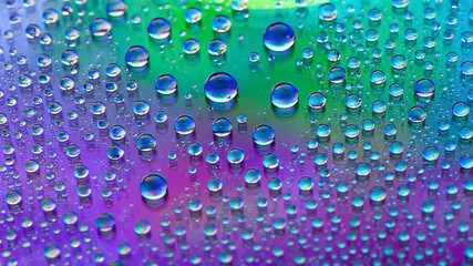 Drops of water. Abstract gradient background. Droplet texture. Iridescent gradient. A highly textured image. Small depth of field. Selective focus