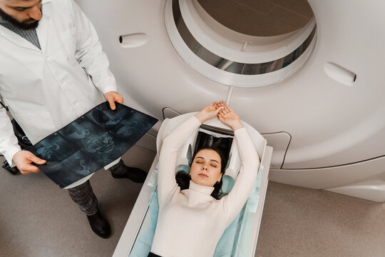 Girl patient is doing CT computed tomography x-ray scan of chest for examination of abdomen in a CT scanning room. CT scan of abdomen of woman in medical clinic.