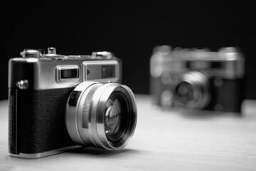 Vintage film cameras on wooden table.