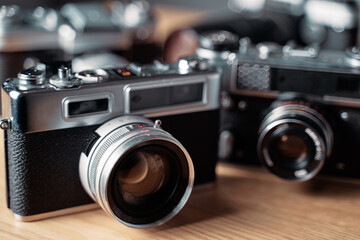 Fototapeta na wymiar Vintage film cameras on wooden table.