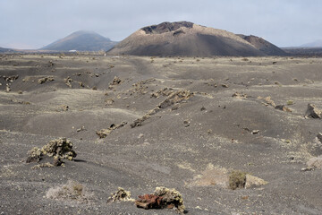 Old volcanic cone surrounded by lava in Tinajo, Lanzarote