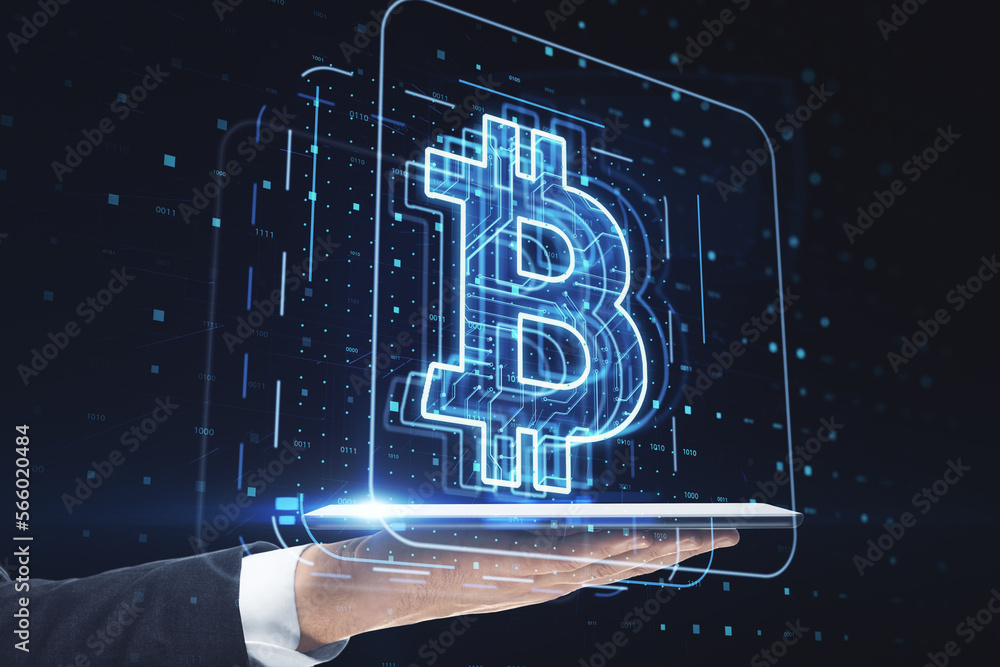 Poster close up of businessman hand holding tablet with glowing bitcoin hologram on blurry dark tech backgr