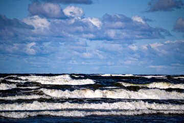 Big waves with white foam on the sea.