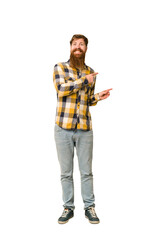 Young adult redhead man with a long beard standing full body isolated excited pointing with...