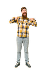 Young adult redhead man with a long beard standing full body isolated surprised pointing with finger, smiling broadly.