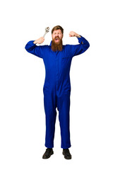 Fototapeta premium Adult mechanic man holding a wrench ful body cut out isolated