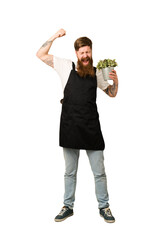 Adult gardener man holding a plant full body cut out isolated
