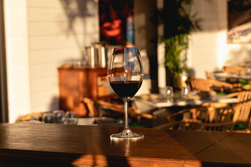Red wine glass in a restaurant fine dining during sunset evening dinner