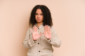 Young african american curly woman isolated rejecting someone showing a gesture of disgust.
