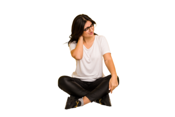 Young indian woman sitting on the floor cut out isolated having a neck pain due to stress, massaging and touching it with hand.
