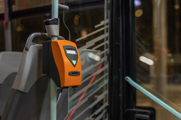 Orange ticket validator as used in public transport in the city of Prague on a city tram.