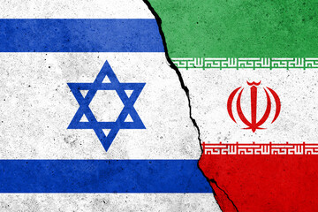 Flags of Israel and Iran painted on the concrete wall with soldier shadow.