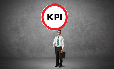 Young business person holdig traffic sign