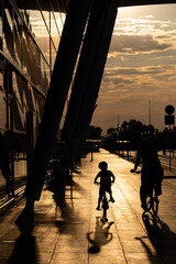 A father and children are on a Sunday tour of the airport towards the sunset. - obrazy, fototapety, plakaty