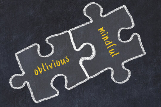 Concept of dealing with troubles. Chalk sketch of connecting puzzles with words oblivious and mindful