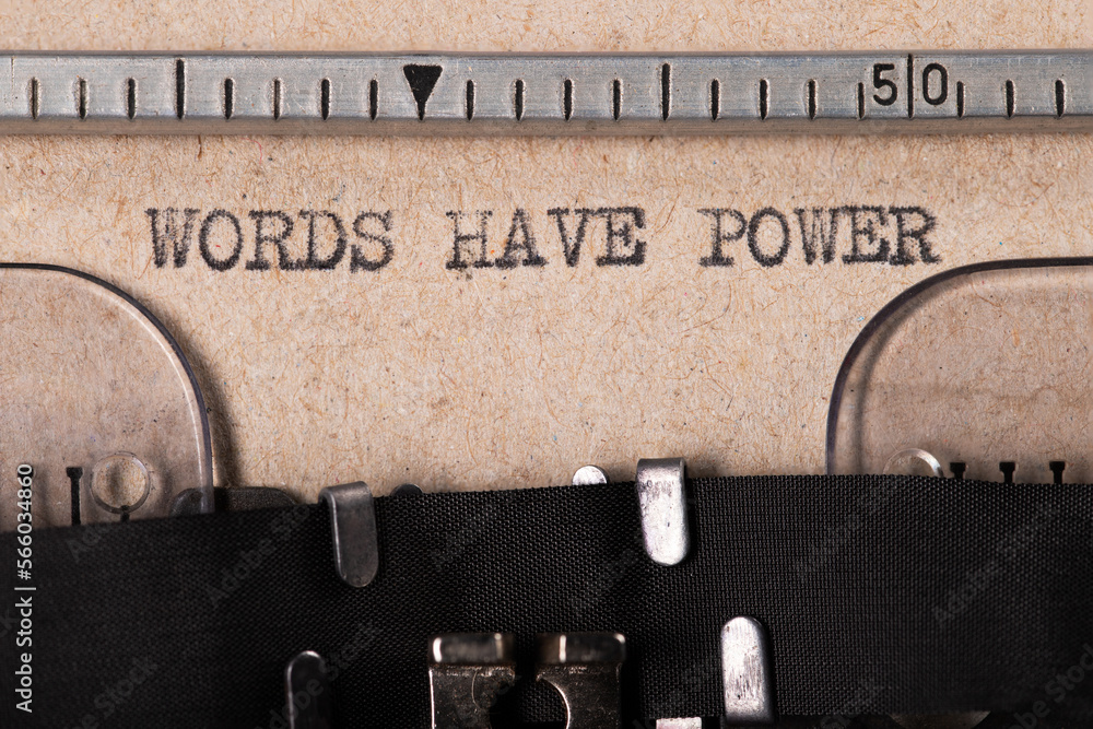 Fototapete the word 'words have power' embossed on gray paper using an old typewriter.