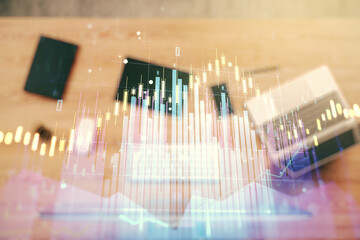 Multi exposure of abstract financial graph on laptop background, financial and trading concept