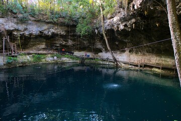 Cenote Xcanche is a stunning open cenote with swimming, zip-lining and swing jumps , there is also a waterfall cascading into the cenote. Located near Valladolid the Yucatan Peninsula , 14 11 2022.
