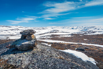 Inukshuk overlooking arctic landscape, Nunavut, Canada.