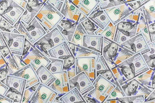 A heap of one hundred US dollar bills as a background, business concept