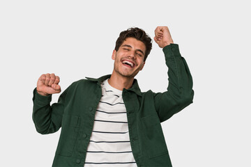 Young handsome caucasian man isolated on white background celebrating a special day, jumps and...