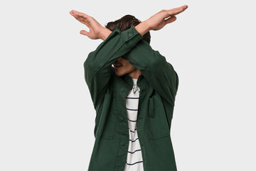 Young handsome caucasian man isolated on white background keeping two arms crossed, denial concept.