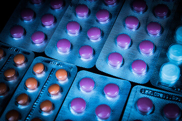 Blisters with red and orange pills