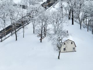 aerial view of a residential house covered in snow