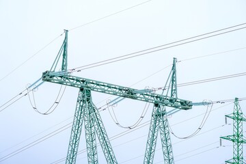 High voltage line with insulators and sky background.