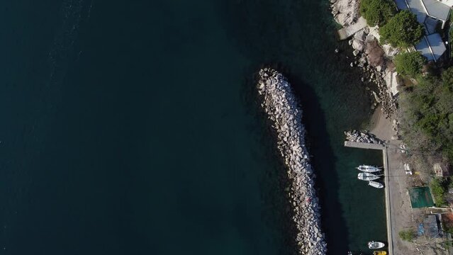 Fantastic landscape taken from the drone at the top of the cliff. Trieste, Italy. Clear sea and blue sky. Rocks and sand.
