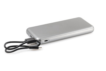 Additional autonomous power bank for charging mobile devices. External battery isolated on white background. Silver charger for a smartphone with a power supply (battery). Full depth of field.
