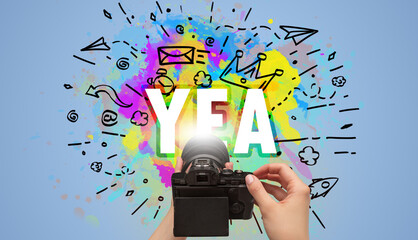 Close-up of a hand holding digital camera with abstract drawing