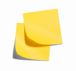 Two yellow office sticky notes with curled corners pasted on the wall. Minimalistic concept of organizing cases, reminders, messaging.