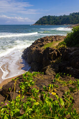 Rocks, waves, sand and vegetation at Praia do Resende beach