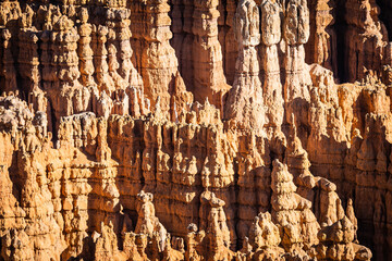 Winter scenery from Bryce Canyon National Park with brilliantly colored orange cliffs and a touch of  snow in Utah.