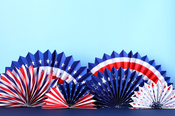 American flag color paper fans on blue background. Banner design for Presidents Day, 4th of July,...