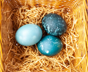 Colorful Easter eggs in a basket. Traditional festive decor.