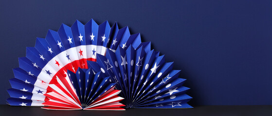 US national holiday banner template with American flag paper fans on navy blue background. Happy...