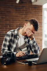 Casual business man with stylus pen writing on digital notepad, touching on digital tablet screen working on laptop computer in office. Paperless business, technology.