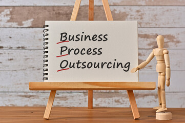 There is notebook with the word Business Process Outsourcing. It is an eye-catching image.
