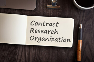 There is notebook with the word Contract Research Organization. It is an eye-catching image.