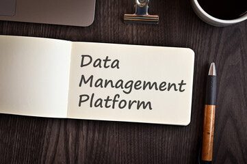 There is notebook with the word Data Management Platform. It is an eye-catching image.