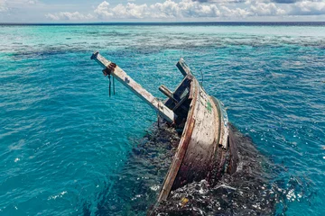 Foto op Canvas Aerial view of a sunken ship near Keyodhoo, Vaavu Atoll, Maldives, Indian Ocean. A place for tourists engaged in diving and snorkeling © Sergey Chips