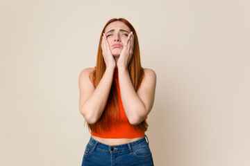 Young red hair woman isolated whining and crying disconsolately.