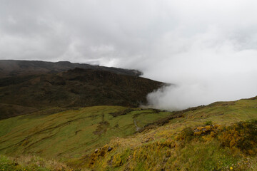 Fototapeta na wymiar Stunning paramo ecosystem landscape with clouds and green grass